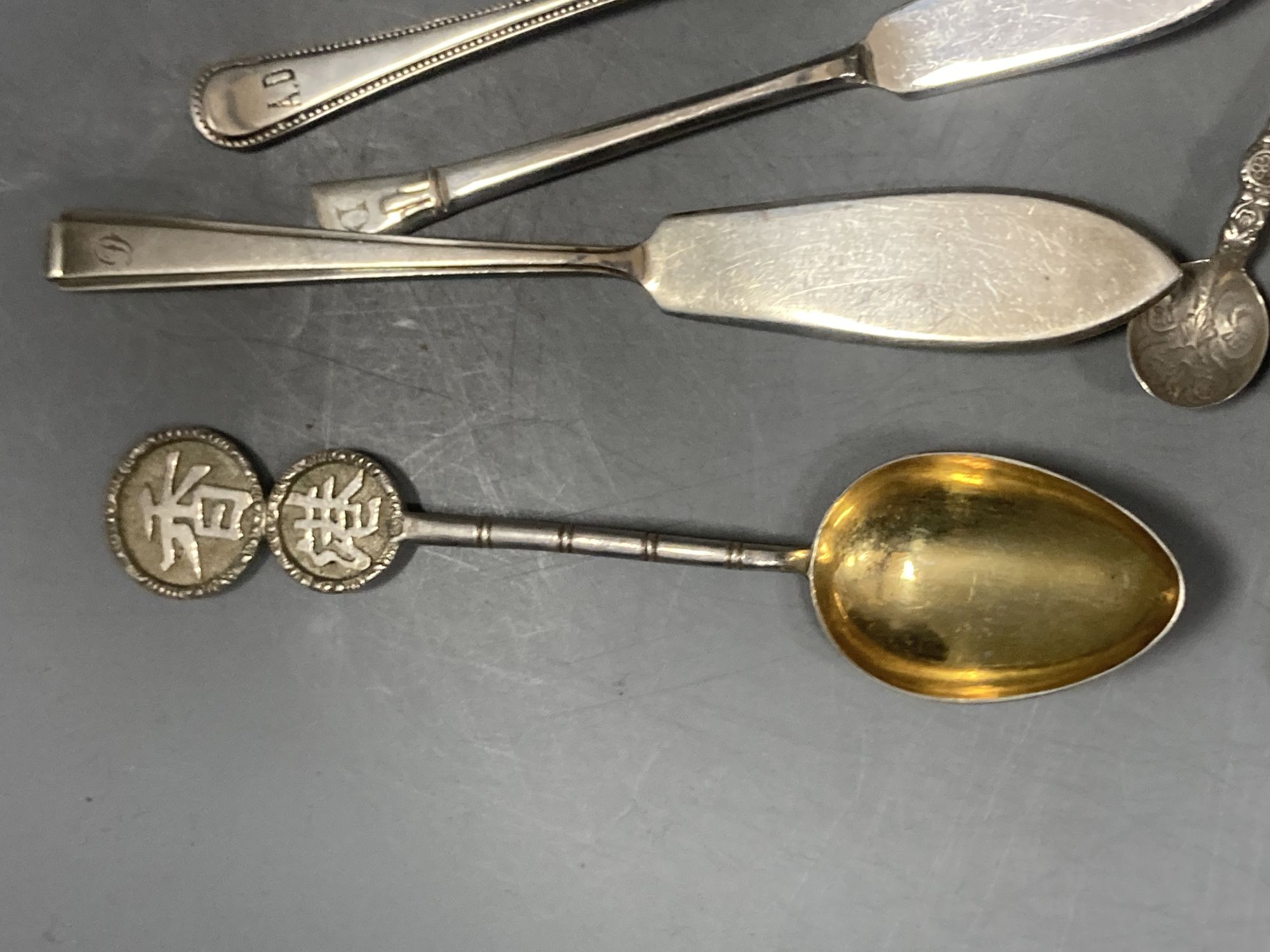 A group of assorted Chinese white metal spoons and forks, including set of six teaspoons and ten small items of English silver.